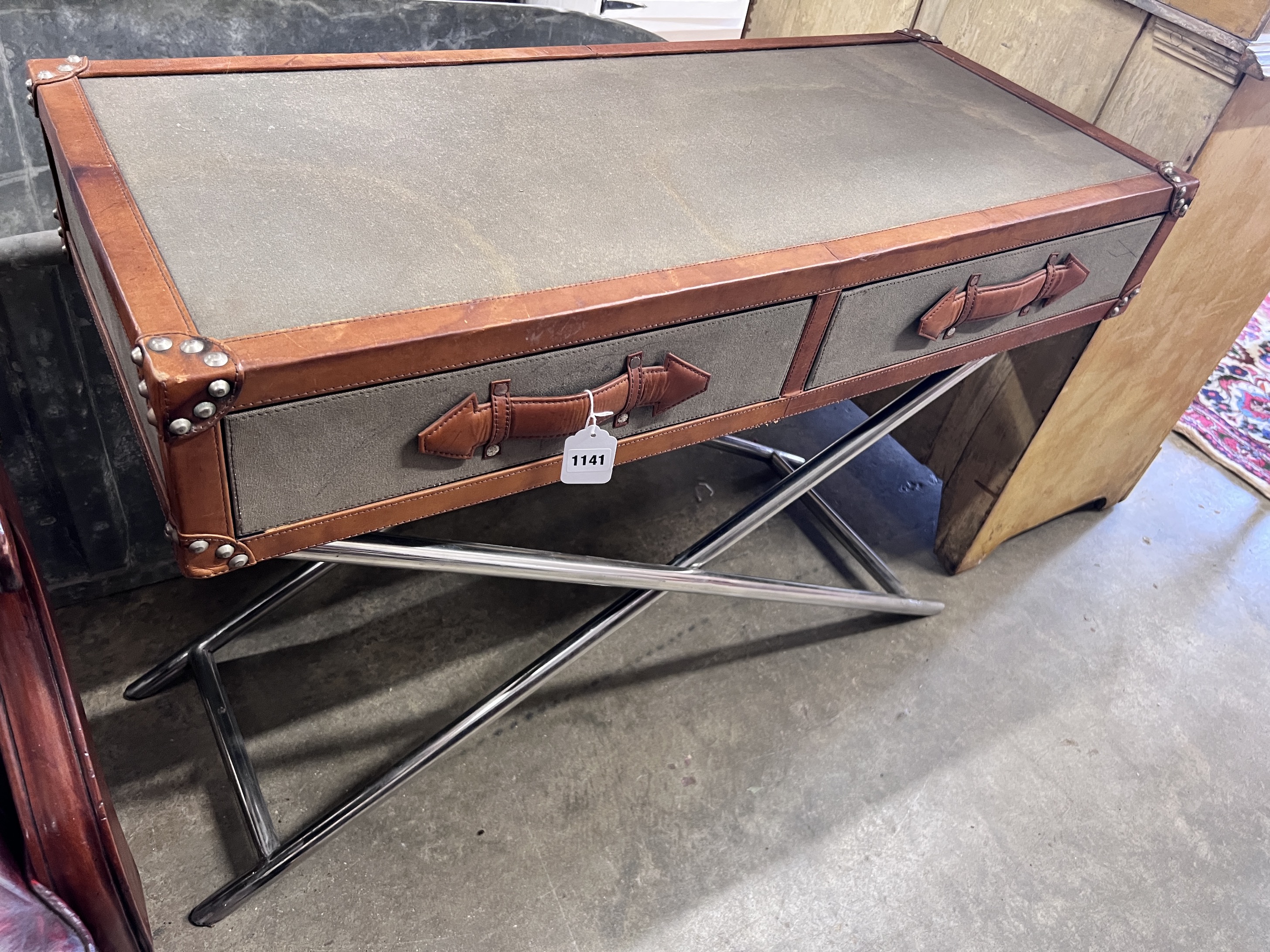 A leather and canvas covered safari style occasional table with chromed folding underframe, width 96cm